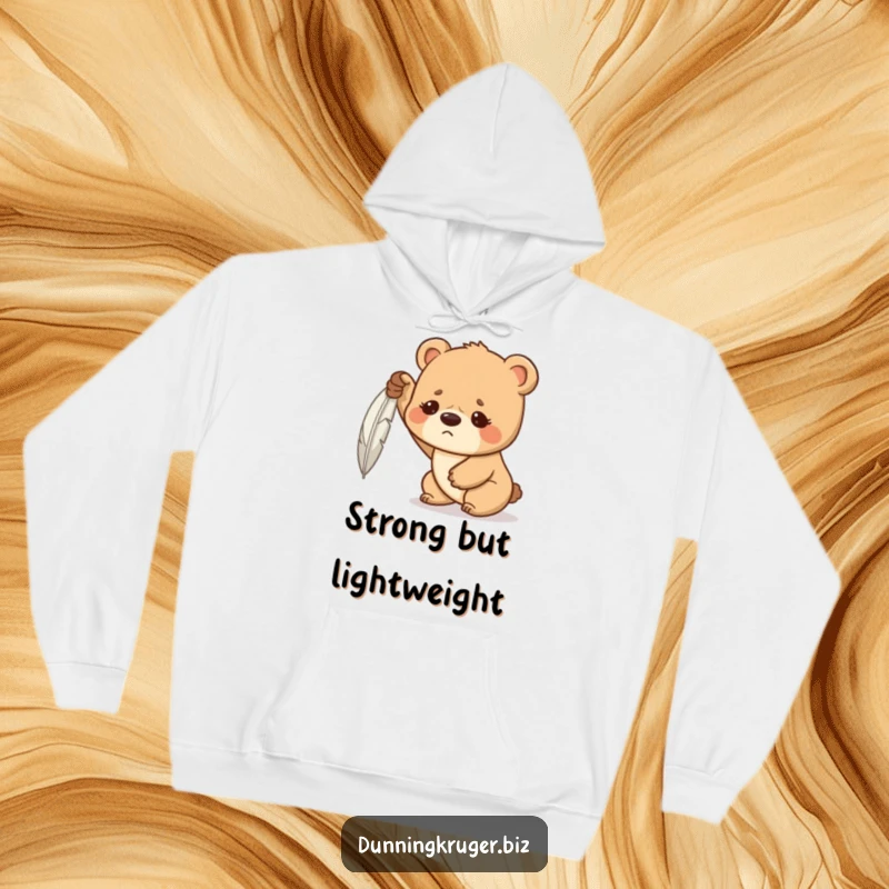 Funny hoodie depicting a determined bear cub with a furrowed brow, hilariously struggling to lift a feather, radiating relatable effort.