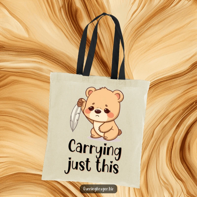 Funny tote bag featuring a determined bear cub with a furrowed brow, hilariously struggling to lift a feather, ideal for carrying life's challenges.